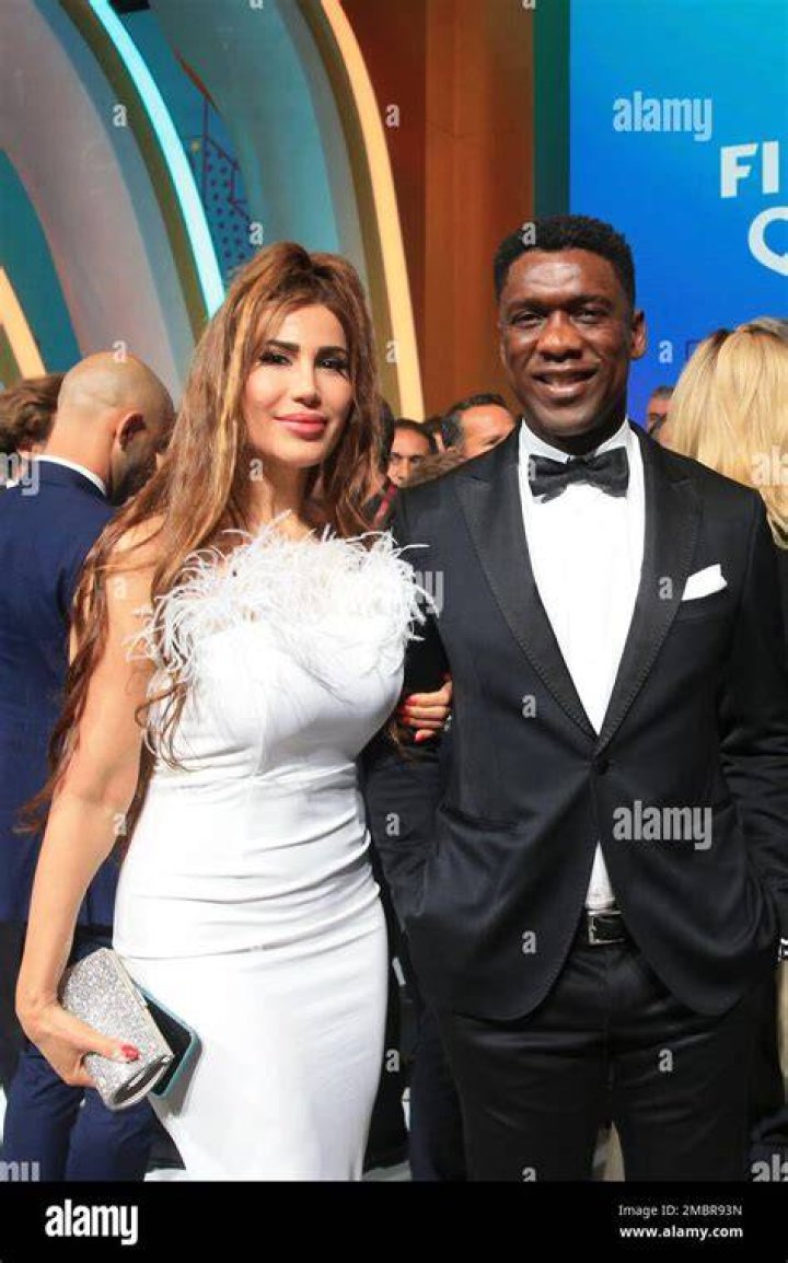 Clarence Seedorf and his wife Sophia Makramati pose following the 2022
